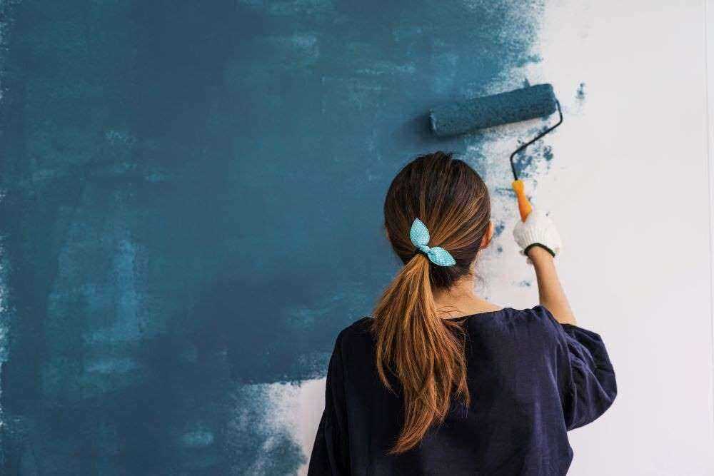 Woman painting a wall