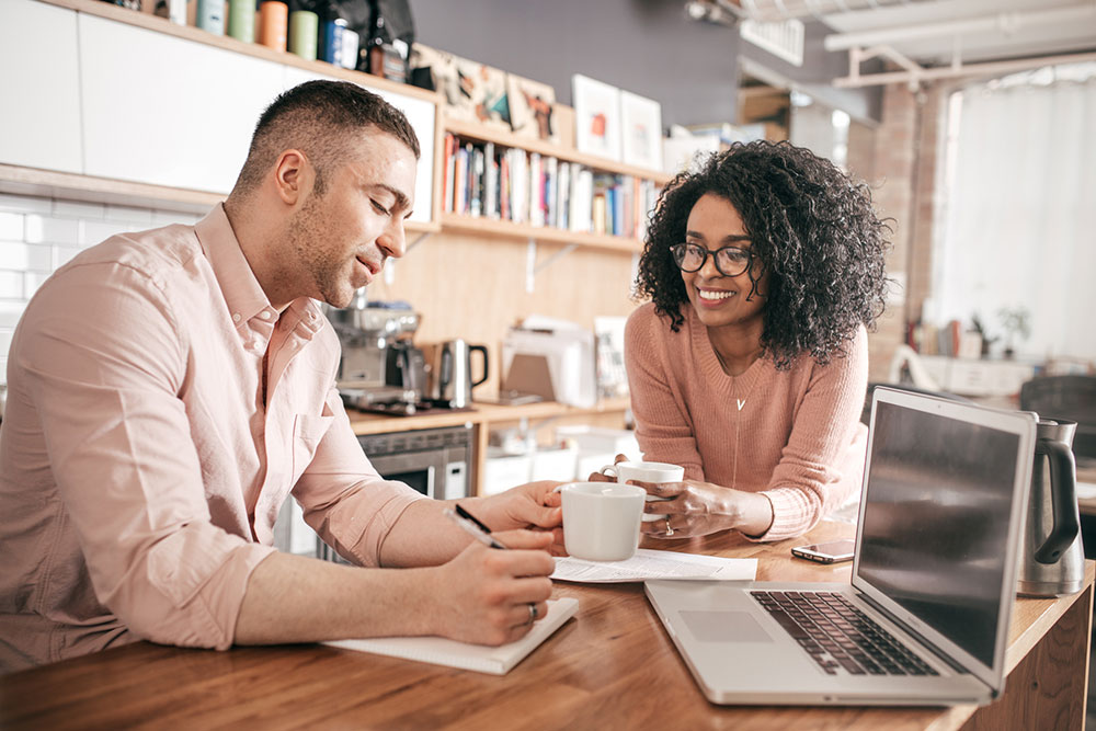 Couple using computer to review money
