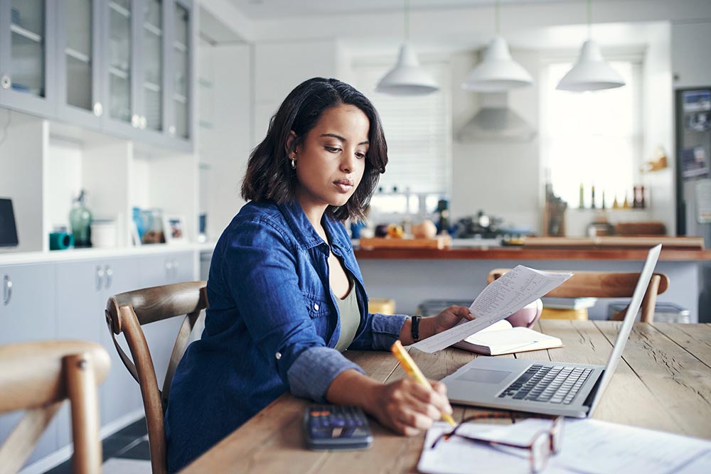 Woman using a computer to work out her finances