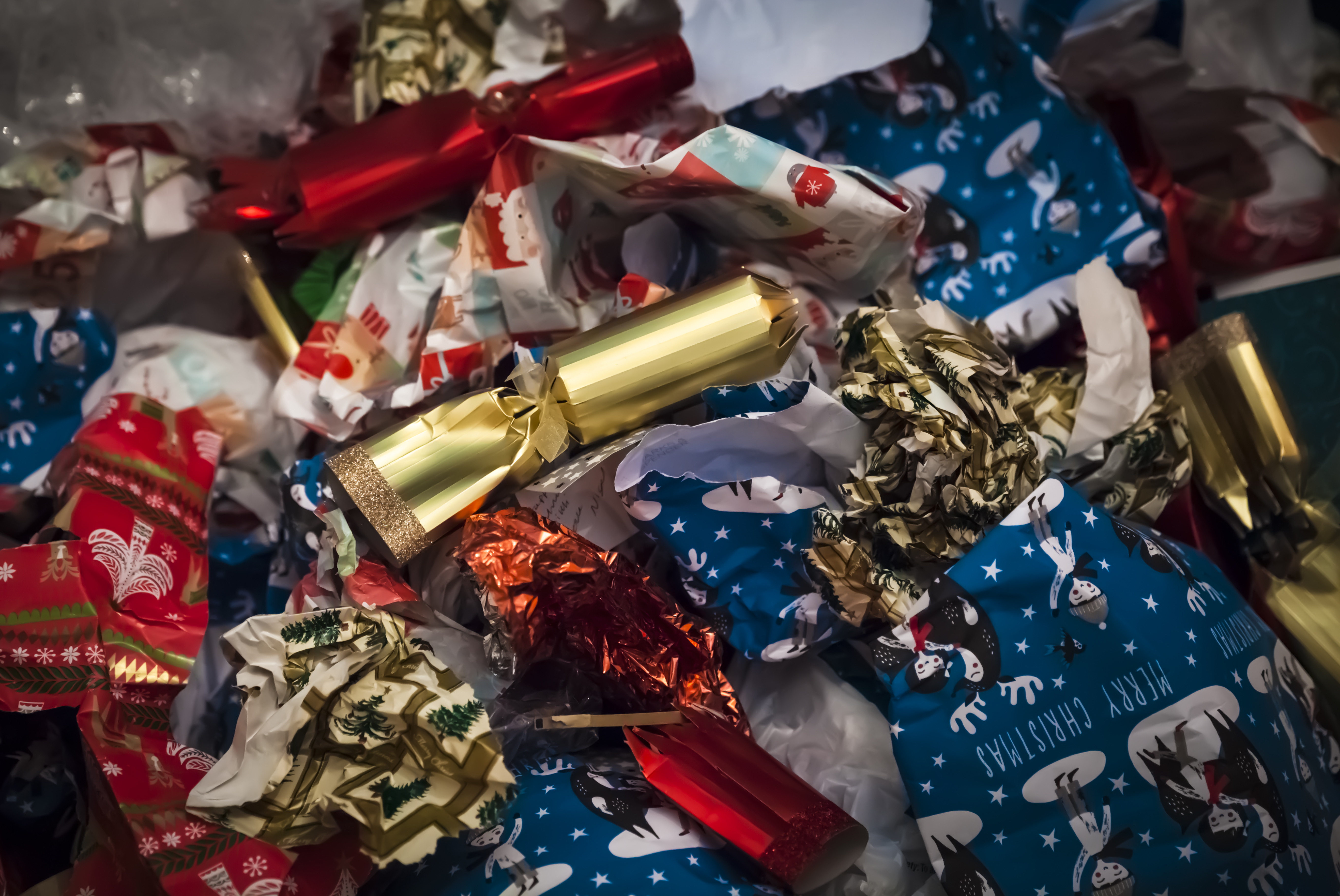 Pile of Christmas wrapping paper and discarded bonbons
