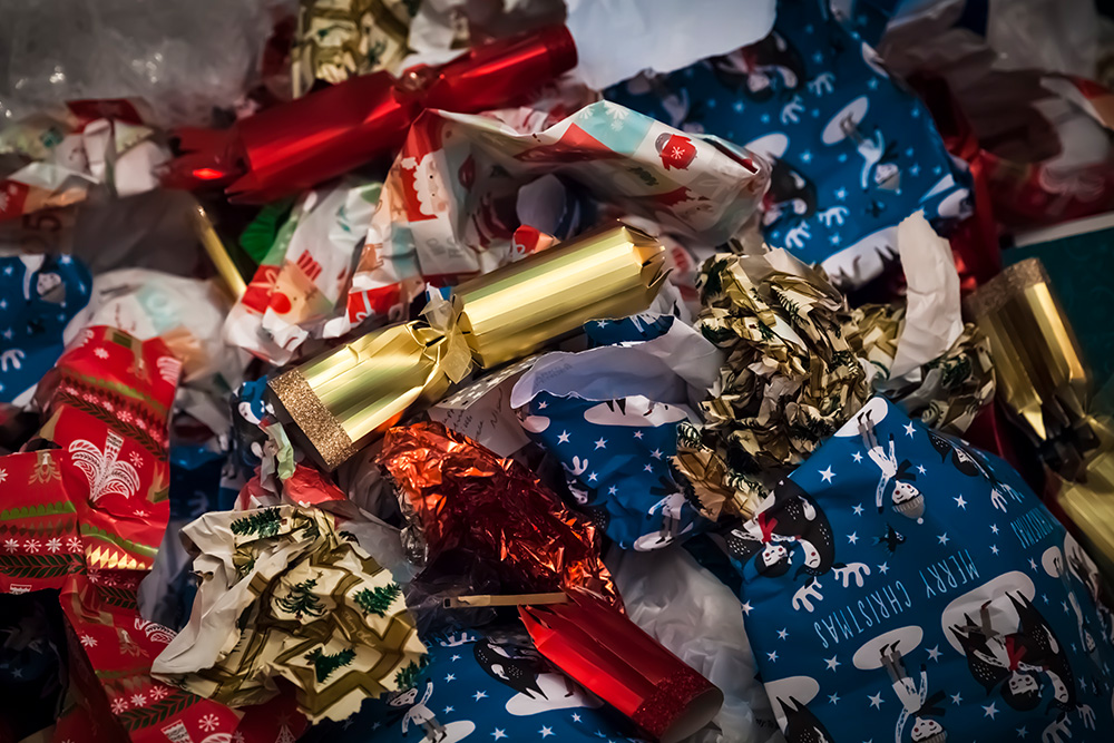 Pile of Christmas wrapping paper and discarded bonbons