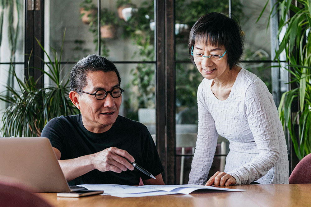 Asian couple looking at paperwork together