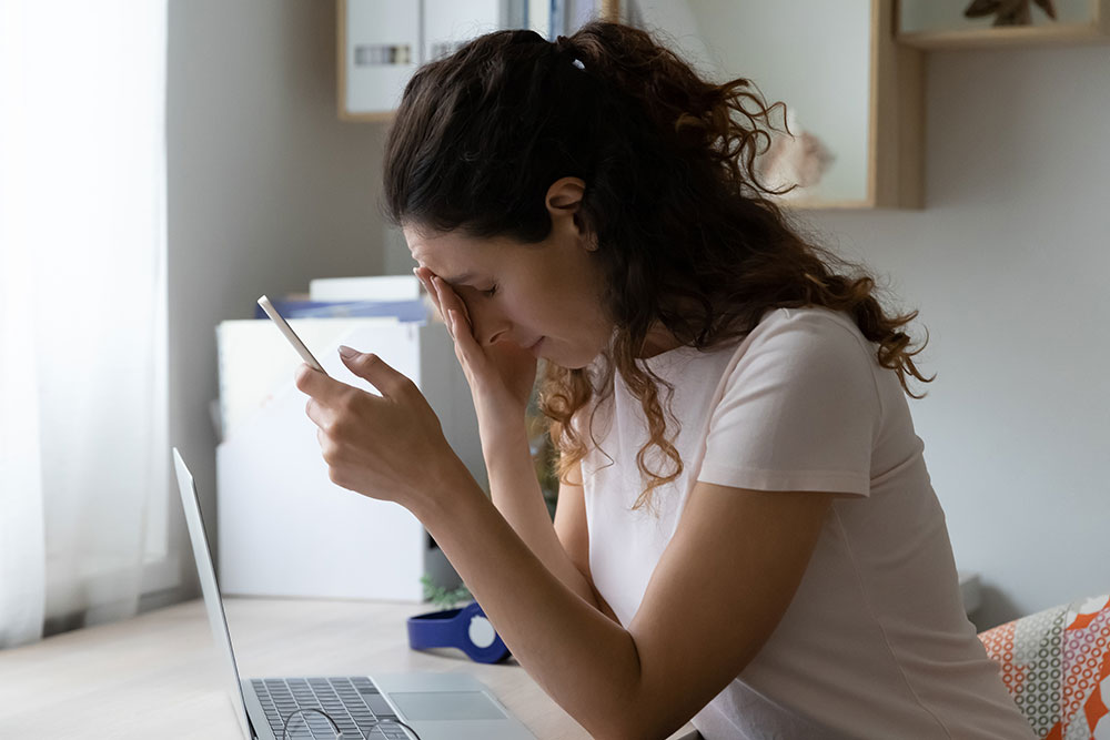 Woman reacts to losing money to online scammers.