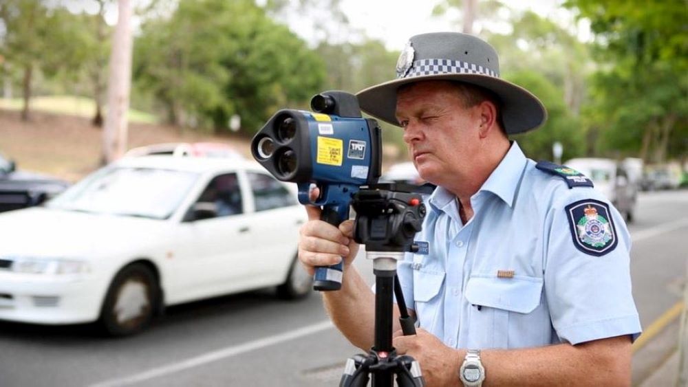 Policeman looking through speed camera