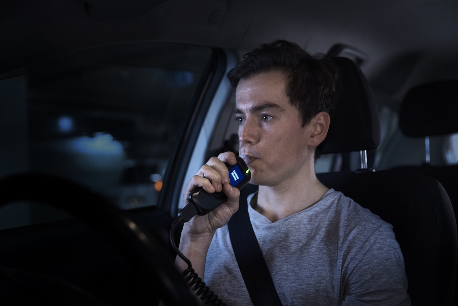 Man blowing into interlock device