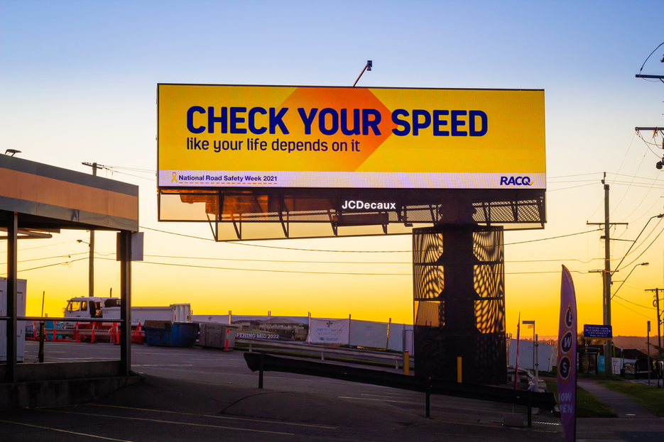 Road safety billboard at sunset