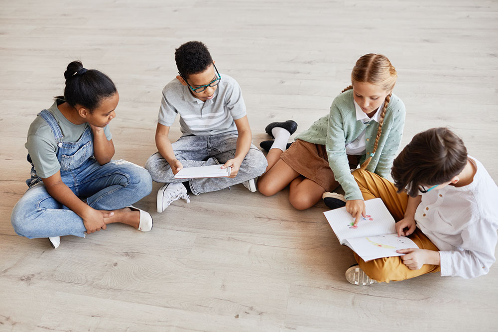 Children sitting on the floor reading books