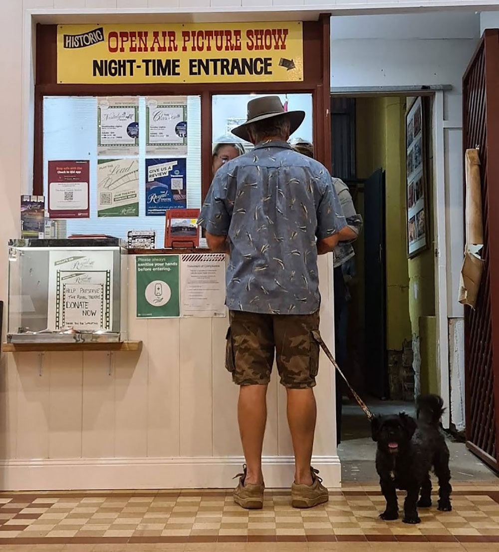 A man buys a movie ticket at Winton's Royal Theatre.