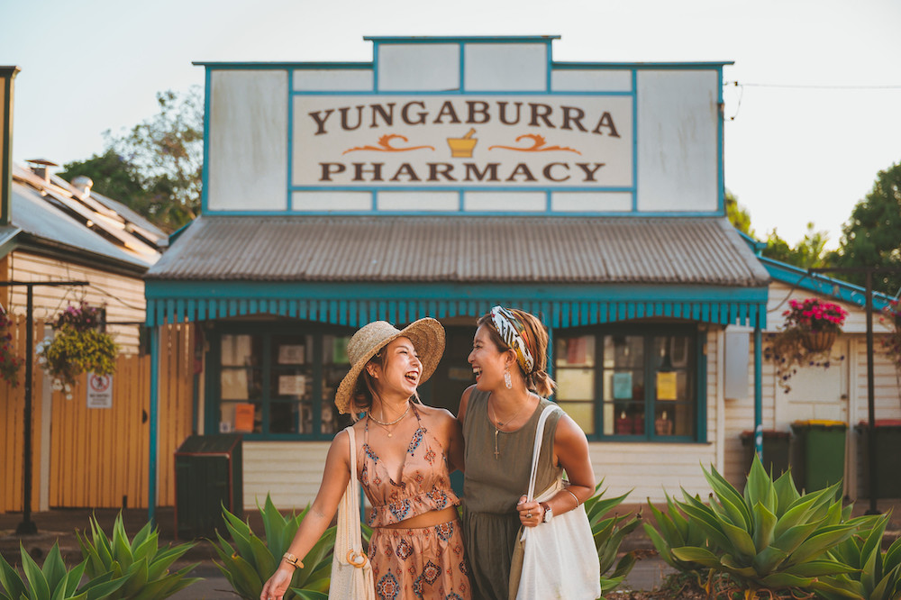 Two women outside the Yungaburra Pharmacy