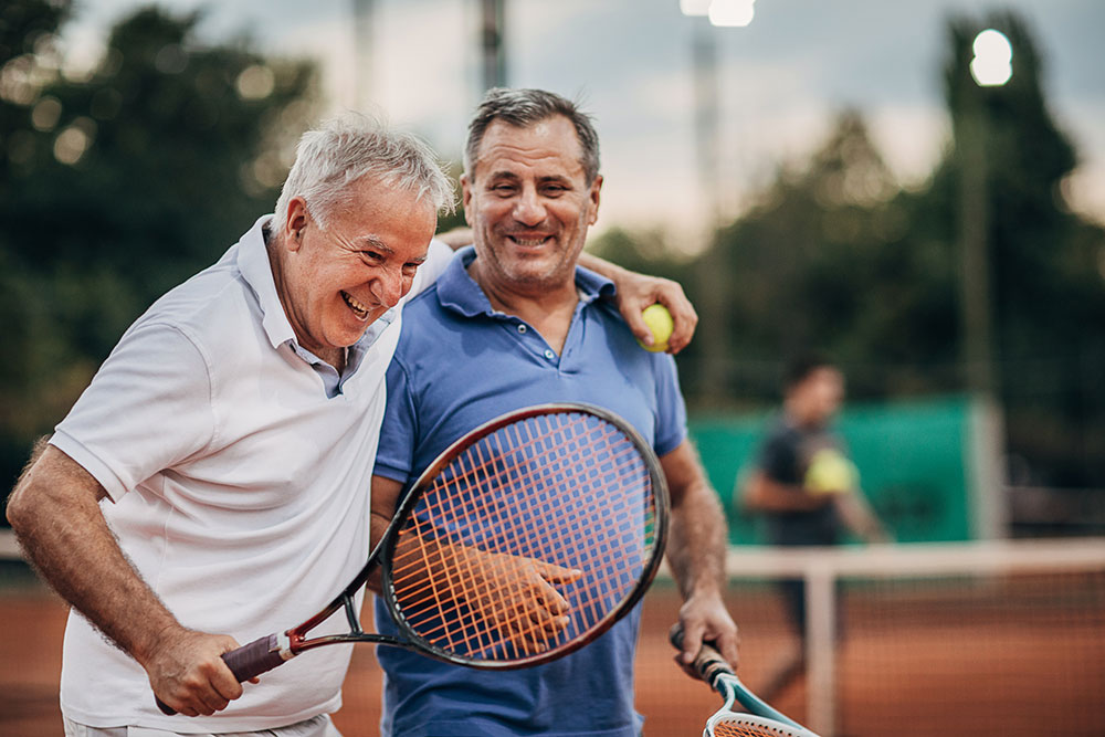Two men pictured after a game of tennis.