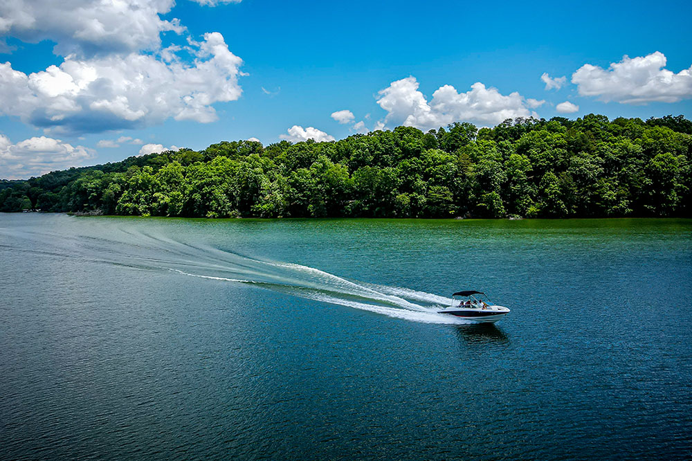 A speed boat powers across water.