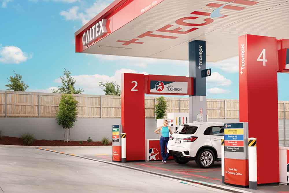 Woman fueling up car at Caltext service station.