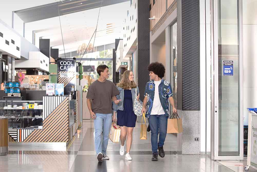 Group of three friends at a shopping centre.