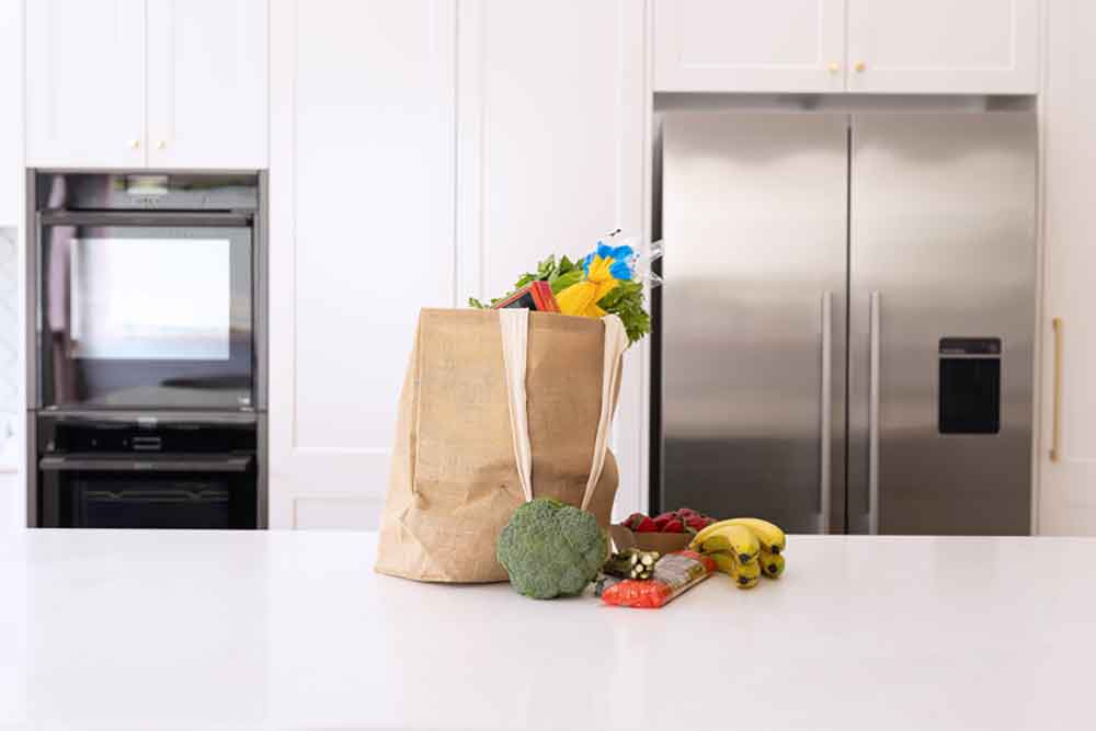 Bag of groceries on a kitchen bench.
