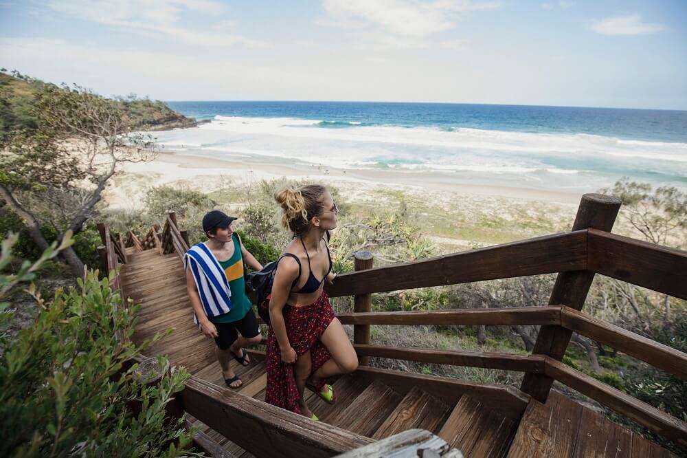 Couple walking up stairs at the beach