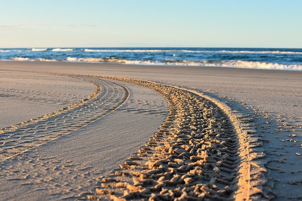 Tyre marks in the sand.