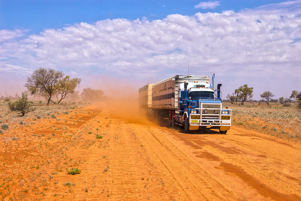 Large truck driving on dirt road