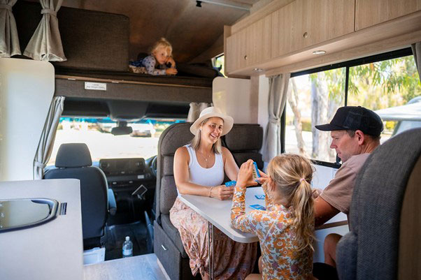 Family relaxing in a camper van.
