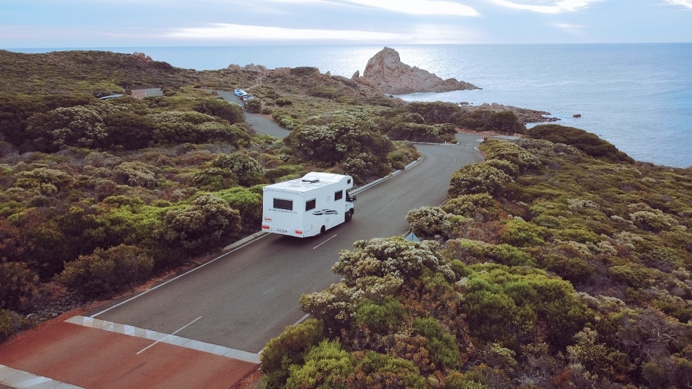 Apollo van driving along a beach road
