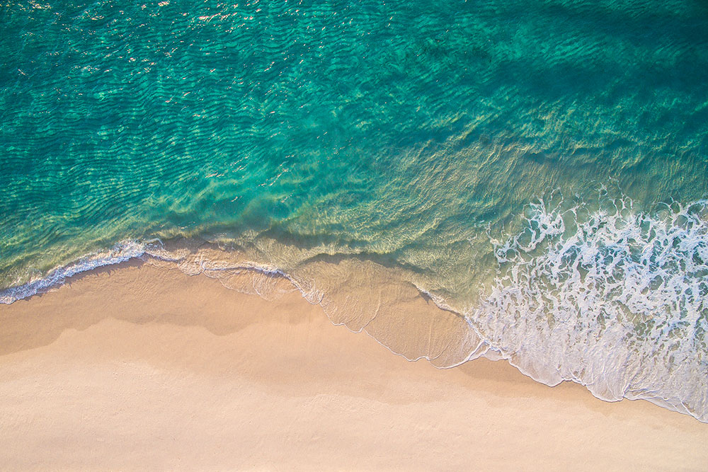 Waves lapping at the shoreline of a beach.