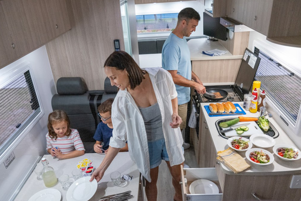family cooking with a view in motorhome