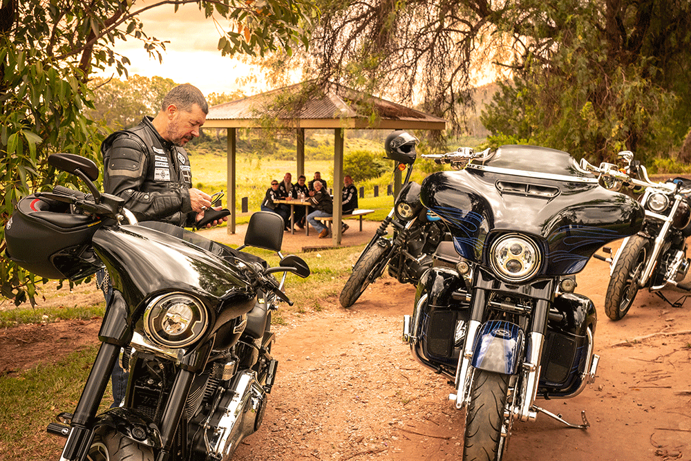 A group of motorcycle  riders rest at O'Shea's Crossing.