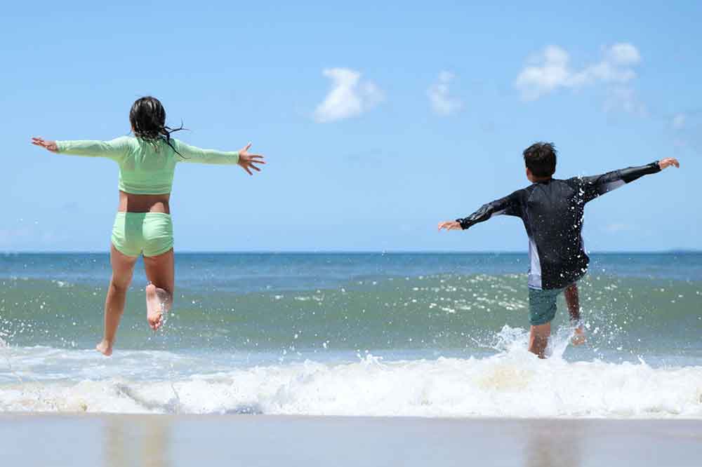 Children playing in the waves on Bribie Island.