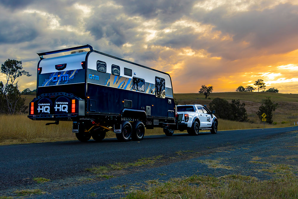 Caravan being towed on road.