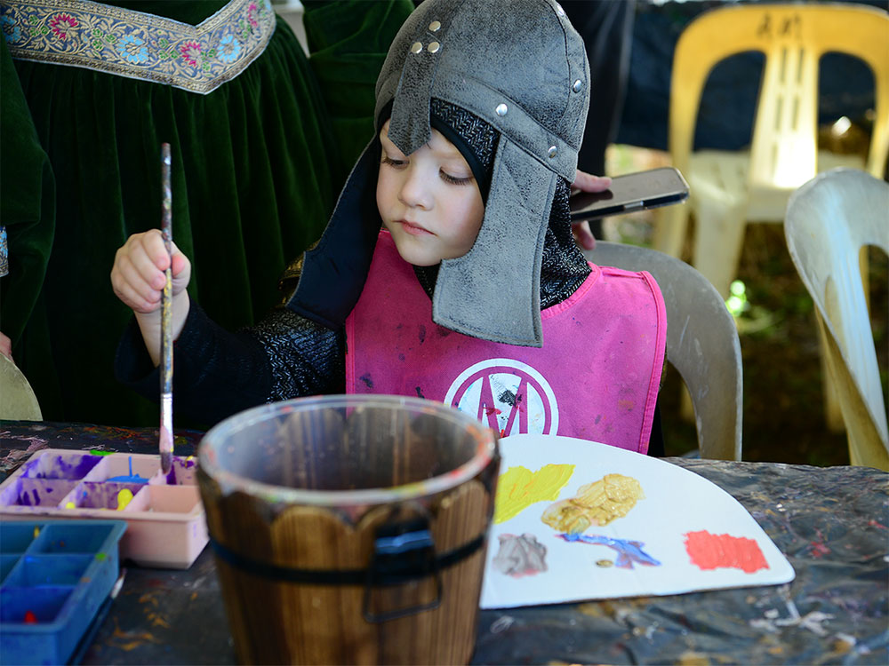 A child painting a picture at Abbey Museum of Art and Archaeology.