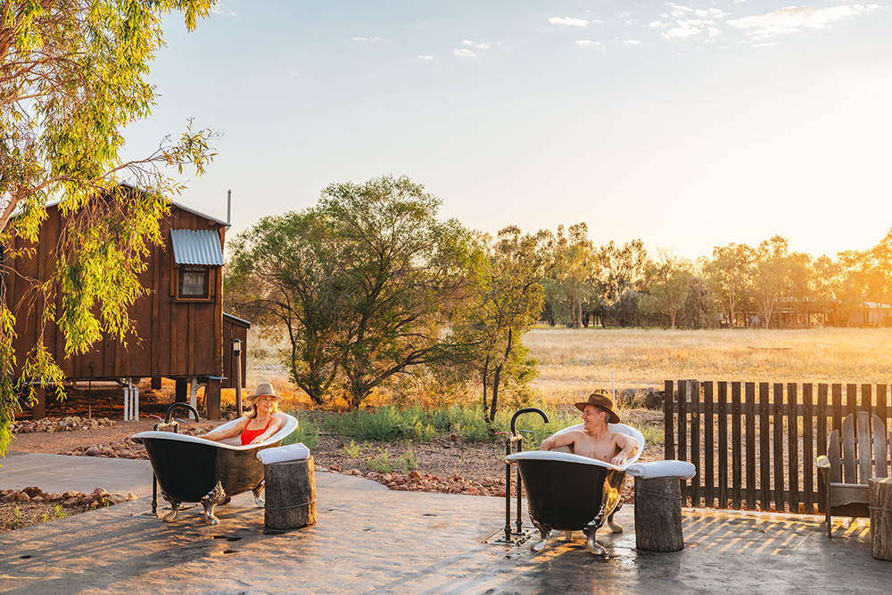 Guests relaxing in outdoor baths at Saltbush Retreat, Longreach.