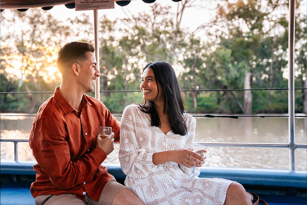 Couple relaxing on a river boat in the Balonne Shire.