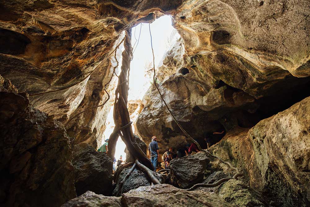 Two people exploring Capricorn Caves.