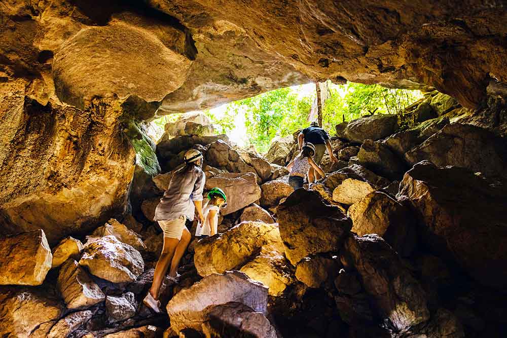 A family exploring one of Capricorn Caves.