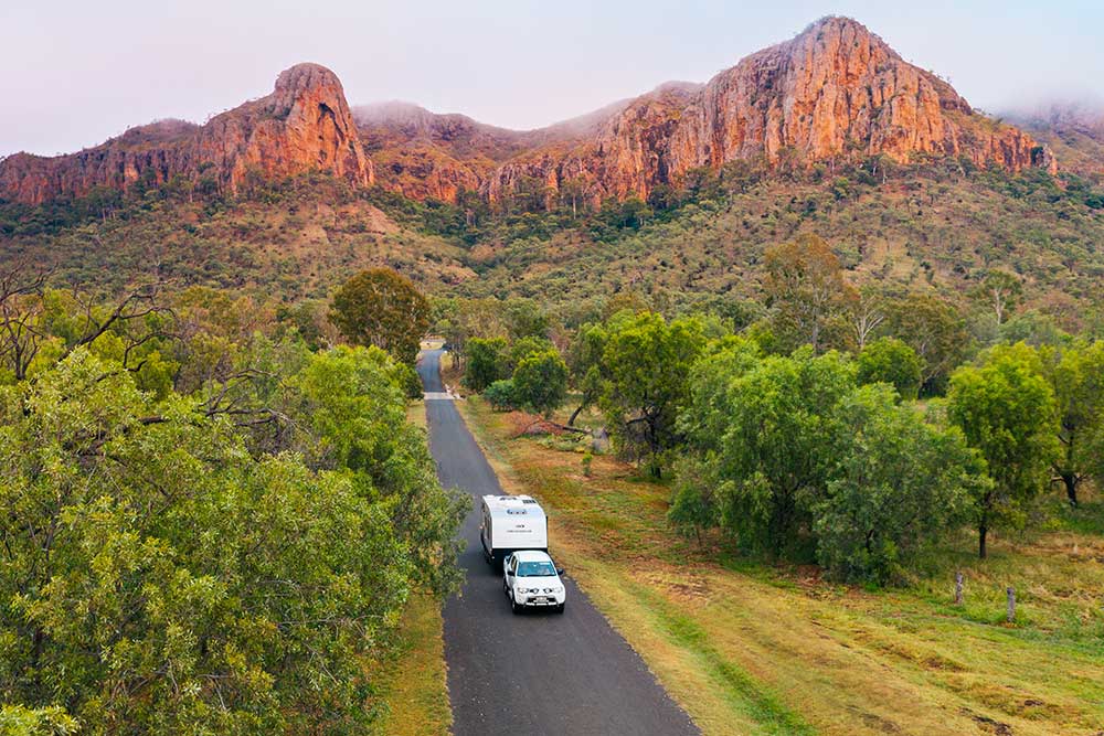 Car towing a caravan at Minerva Hills National Park.