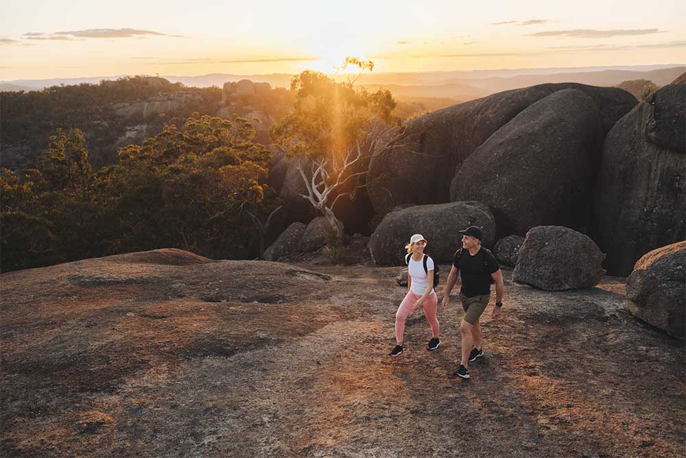 Couple walking on rock in Girraween National Park