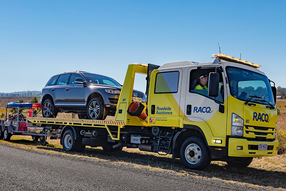 RACQ Roadside Assistance towing a vehicle on side of road
