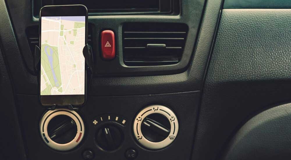 mobile phone in cradle of car dash