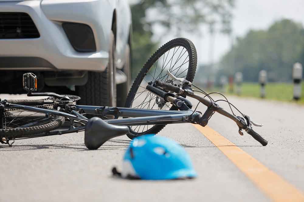 bicycle lying in street after car accident