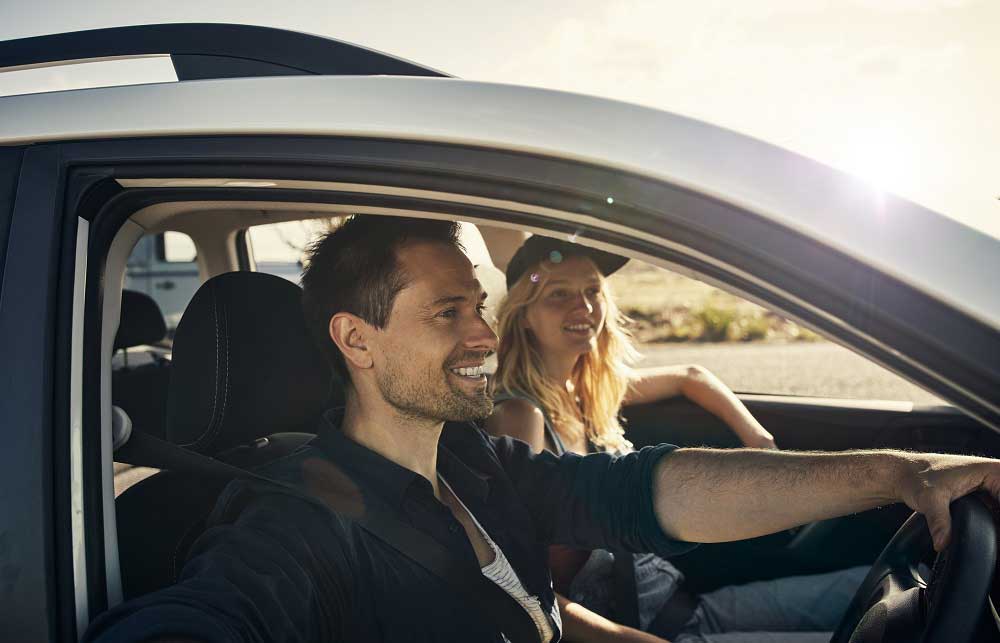 Man and woman in car smiling
