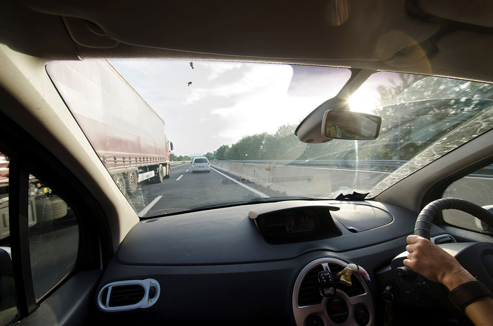 Driver overtaking truck on highway.