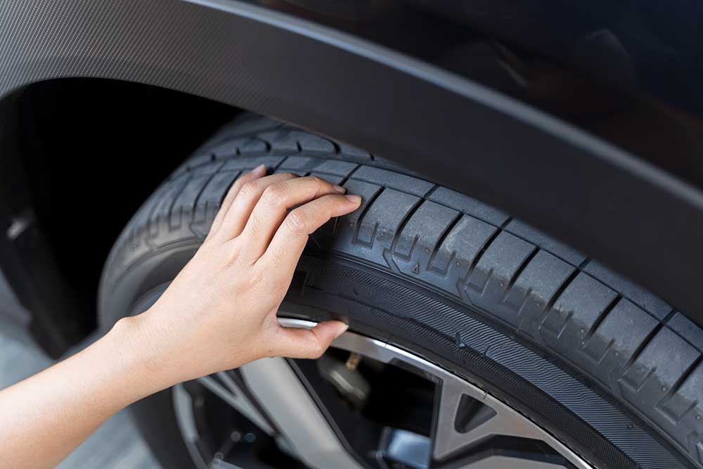 checking car tyre for damage