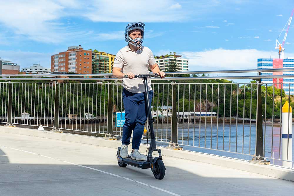 E-scooter rider wearing a full-face helmet.