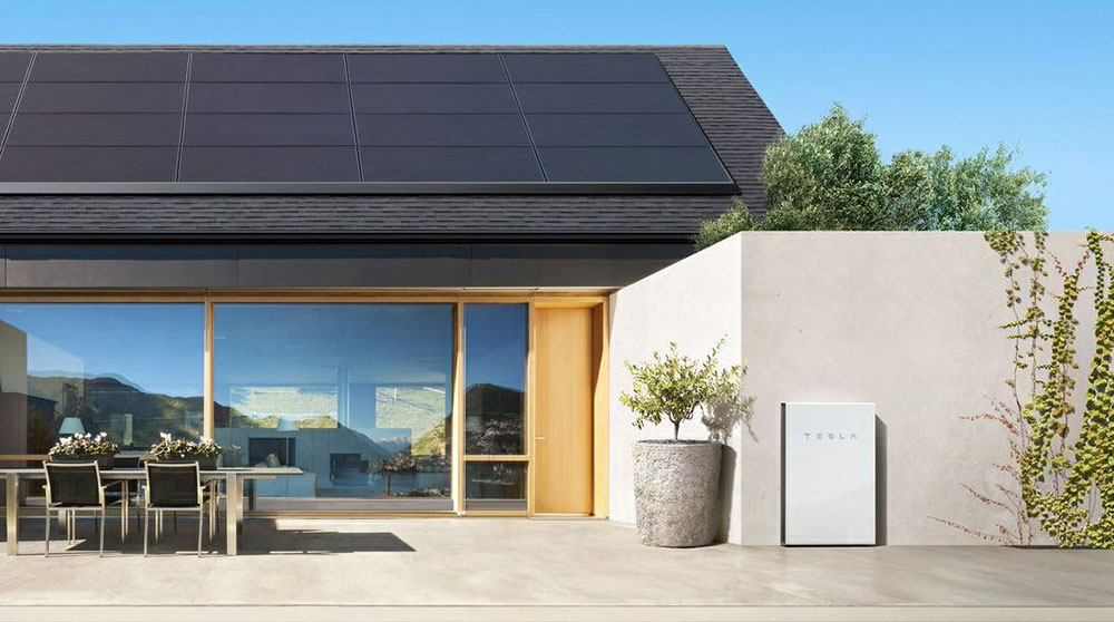 Home with solar panels and Tesla battery.