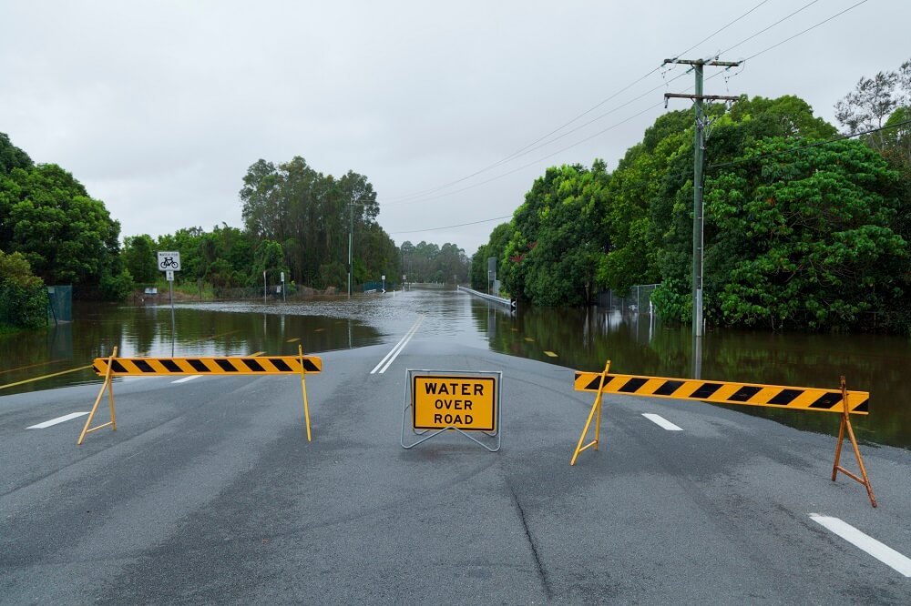 Signs warning motorists of flooded road.