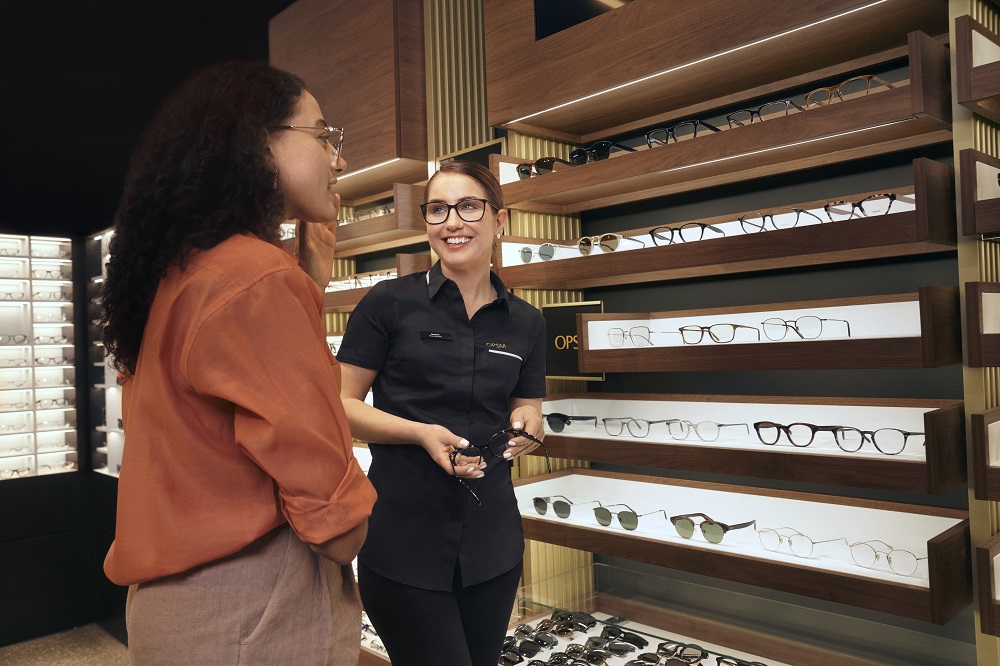 Woman looking at a selection of glasses to purchase in an OPSM store