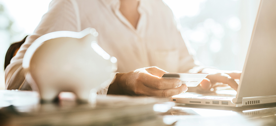 woman shopping online with credit card on their laptop
