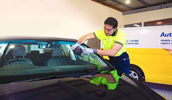auto glass guy cleaning windscreen