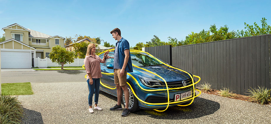 Boy learning to drive with mum