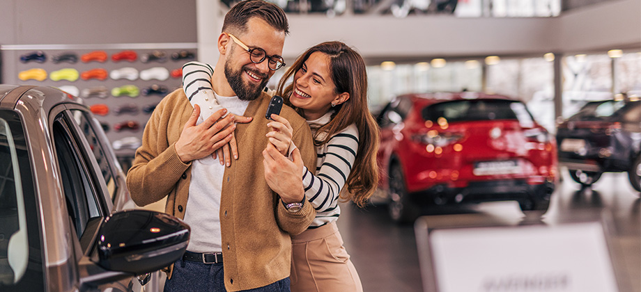 car buying couple at show room