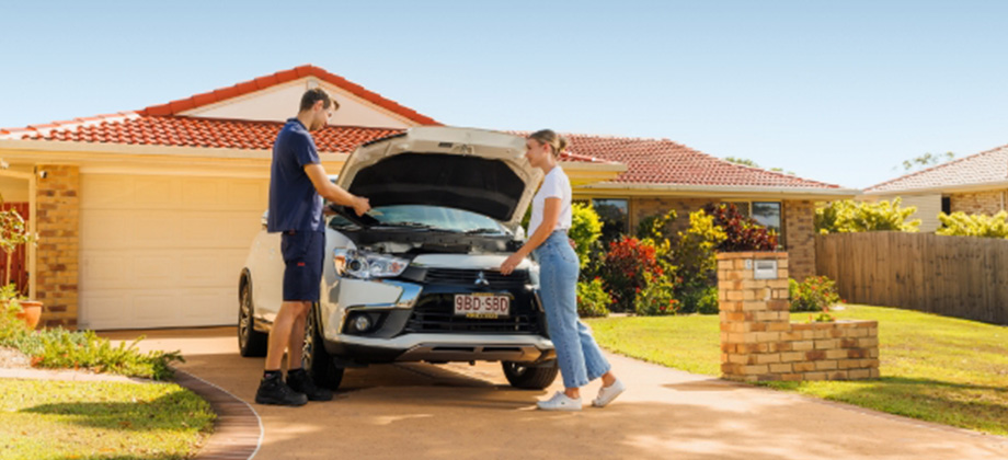 man-showing-young-woman-car-maintenance